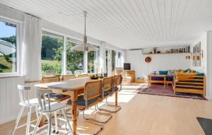 a dining room and living room with a table and chairs at 3 Bedroom Stunning Home In Ebeltoft in Ebeltoft