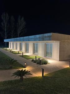 a building with lights in front of it at night at TERMAS PISMANTA Hotel & Spa in Las Flores