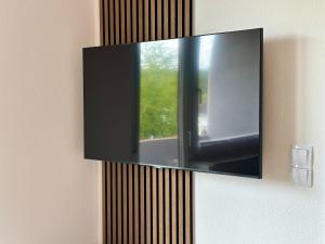 ein Spiegel hängt an einer Wand mit einem Fenster in der Unterkunft Ferienwohnung Rotenfelsblick in Bad Kreuznach