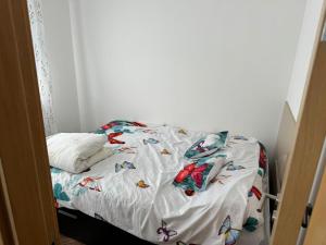 a bed with a white bedspread with butterflies on it at Superior house on water in Ostružnica