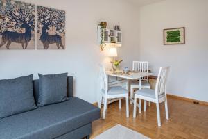 a living room with a couch and a table at Auszeit im Waldhaus in Hintertal