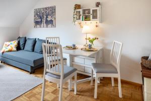 a living room with a table and chairs and a couch at Auszeit im Waldhaus in Hintertal +17 photos