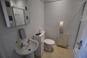 a white bathroom with a toilet and a sink at Park View Guest House in Bridlington
