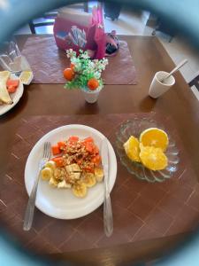 a table with a plate of food on a table at Hotel Pousada Paraiso Avaré in Avaré
