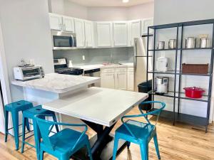 a kitchen with a table and four blue chairs at 204-Bright 2Bed 2Ba w Stainless Steel Appliances in Hoboken
