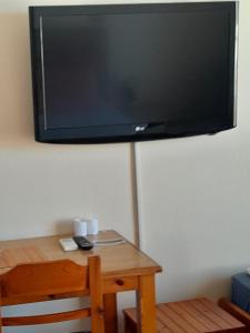 a flat screen tv hanging on a wall at Santi house in Souvala