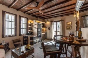 a living room with a table and a kitchen at Domus Castrum in Naxos Chora