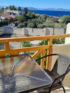 una silla en el balcón con vistas al océano en Santi house, en Souvala