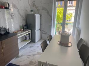 a kitchen with a table and a refrigerator at Centralissimo 50mt in Matera