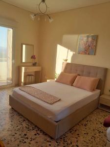 a bedroom with a large bed and a window at Santi house in Souvala