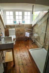 a bathroom with a sink and a shower and a toilet at Stylishly decorated 3 bed home close to the sea on the Wirral Peninsula in Hoylake