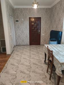 a dining room with a table and chairs and a door at Дом для одыха in Tbilisi City