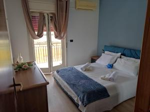 a bedroom with a bed with two towels on it at Stella Marina in Giardini Naxos