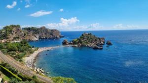 an island in the middle of the ocean at Stella Marina in Giardini Naxos