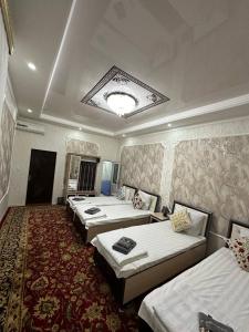 a group of four beds in a hotel room at Khan hotel in Khiva