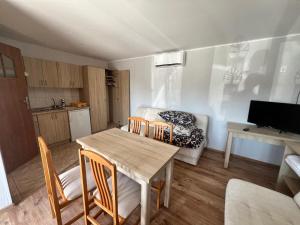 a living room with a table and chairs and a couch at Na Spokojnie in Jastarnia