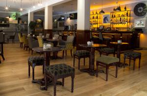 a restaurant with tables and chairs and a bar at Springhill Hotel Kilkenny in Kilkenny +15 photos
