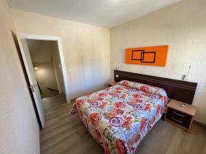 a bedroom with a bed with a colorful bedspread at Retiro Park II - Serviden in Denia