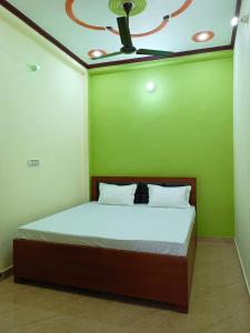 Ayodhya的住宿－Om Home Stay，一间卧室配有一张带吊扇的床