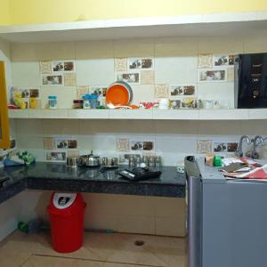 a kitchen with a sink and a counter top at Om Home Stay in Ayodhya