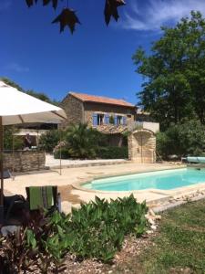 a swimming pool in front of a house at mas de costebelle in Bollène