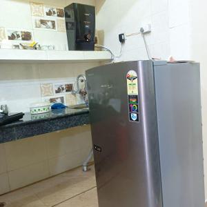 a stainless steel refrigerator in a kitchen at Om Home Stay in Ayodhya