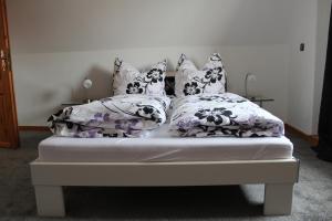 Bett mit Kissen darauf in einem Zimmer in der Unterkunft Ferienhaus Wingarda in Weingarten