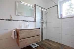 a bathroom with a sink and a shower at 90m² Top Holiday Home Upper Bavaria + Munich South in Schäftlarn