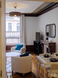 een woonkamer met een bank en een tafel bij Le Berbisey Dijon Centre in Dijon