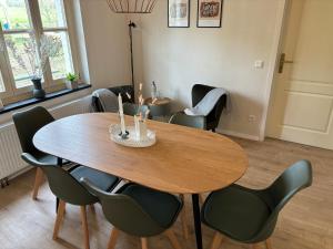 a dining room with a wooden table and chairs at Scheunenwohnung in der Natur in Melle