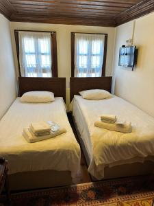 two beds in a room with two towels on them at SEMRA HANIM KONAĞI in Safranbolu
