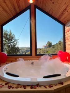 a bath tub in a room with two windows at Five Stars Apart in Trabzon