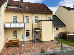 a house with a bench in front of it at Abelia Ferienwohnung GröF in Helmstedt