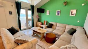 a living room with a couch and a table at Beach Apartment w Sea Views, 3x Bedrooms w En-Suites in Šibenik