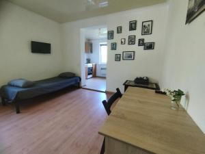 a living room with a couch and a table at Apartments center - Затишні апартаменти в центрі біля ЦУМа in Poltava