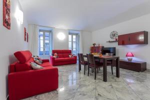uma sala de estar com um sofá vermelho e uma mesa em Carlo Alberto House by Wonderful Italy em Turim