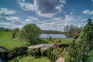 a garden with a view of a lake at Apartament Kaszubski in Ostrzyce