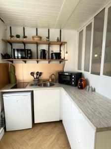 a kitchen with white cabinets and a counter top at Lovely plage - St François - Mer in Le Havre