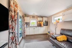 a living room with a couch and a kitchen at Haus Ferdi in Koblenz +17 photos