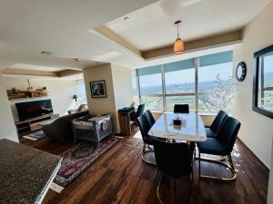 a living room with a table and chairs and a couch at Centaurus Apartment in Islamabad