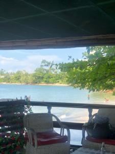 a view of a beach from a window with chairs at Kribi Trip Experience in Kribi