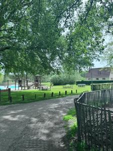 a park with a playground and a fence at Villa vakantiehuis in Ewijk