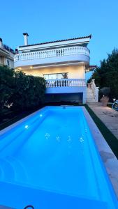 a house with a swimming pool in front of a house at POOL Family House 500m from beach Southplace63 in Vari