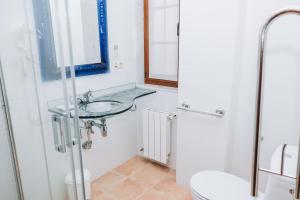 a bathroom with a sink and a toilet at Casa Veiga in Valdoviño