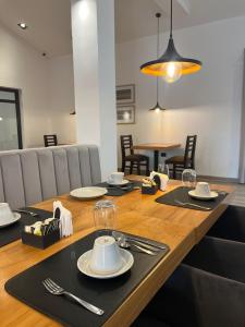 a table with plates and silverware on top of it at TERMAS PISMANTA Hotel & Spa in Las Flores +60 photos