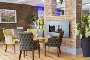 a dining room with a table and chairs at Springhill Hotel Kilkenny in Kilkenny