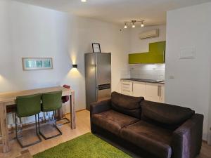 a living room with a couch and a kitchen at BC Better Choice Apartments in Senj