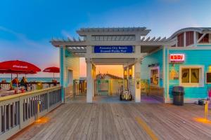 a building on a boardwalk with the ocean in the background at Lake Town Wharf in Panama City Beach