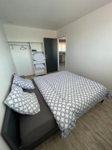 Кровать или кровати в номере Appartement - location saisonnière