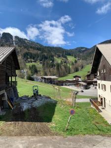 a playground in a field next to a building at 2 pièces La Clusaz Centre village dans petite résidence in La Clusaz